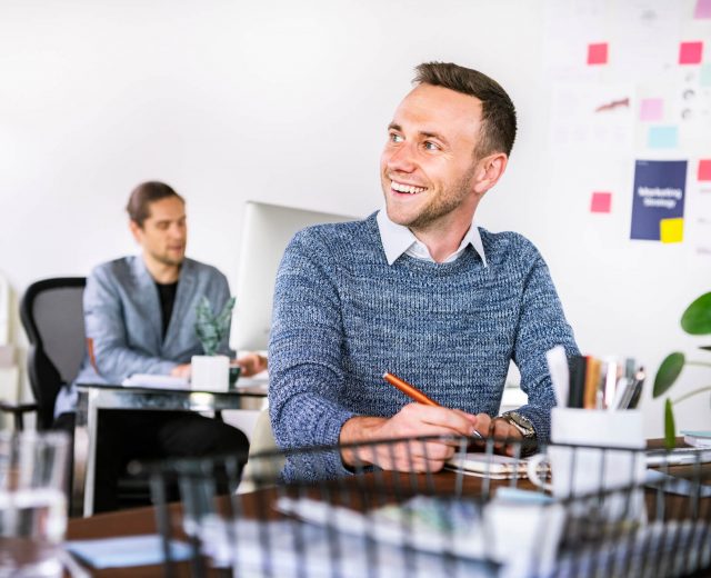 happy-businessman-taking-notes-in-the-office-2021-09-02-06-03-46-utc.jpg